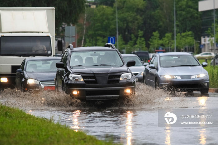 暴雨引发洪水期间，汽车在被洪水淹没的道路上行驶。汽车漂浮在水上，洪水泛滥