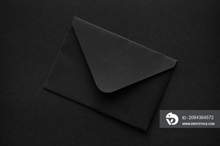 Black envelope on a black background.