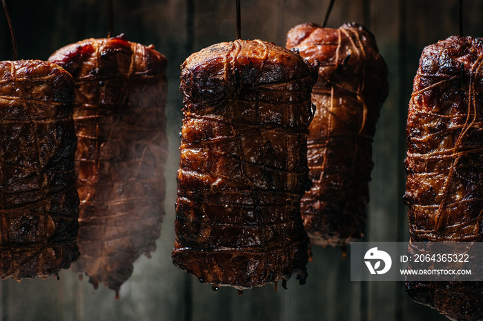 Smoked pork. Traditional method of smoking meat in smok in a homemade smokehouse