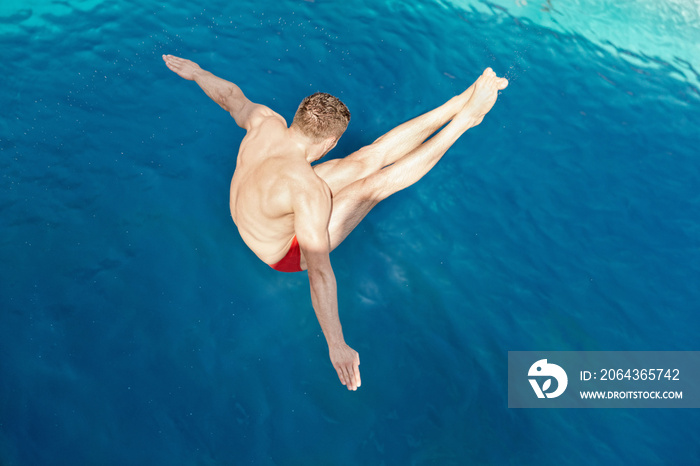 Diving competitor flipping in the air on the way to the water