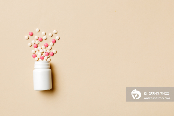 Multicolored pills and capsules in plastic bottle on Colored background, copy space. Many different 