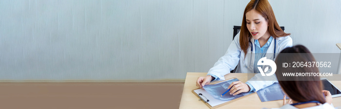 Banner Two asian women doctors discuss meeting office medical clinic. Young asian female doctor look