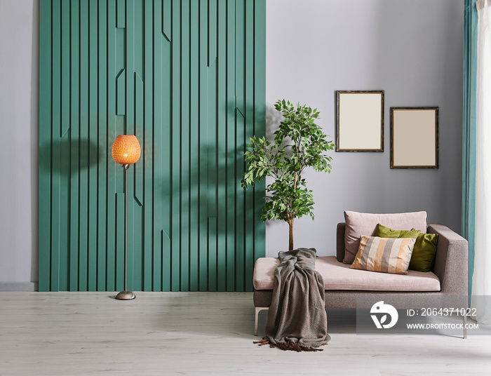 Home interior room, orange lamp, grey sofa vase of plant and frame.