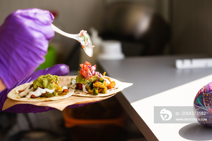 Mexican street fast food with tacos and salsa. Chef preparing food in food truck