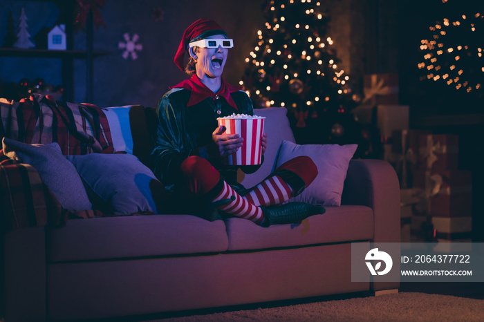 Full size photo of amazed elf sit couch watch three dimensional film with pop corn box in evening ch