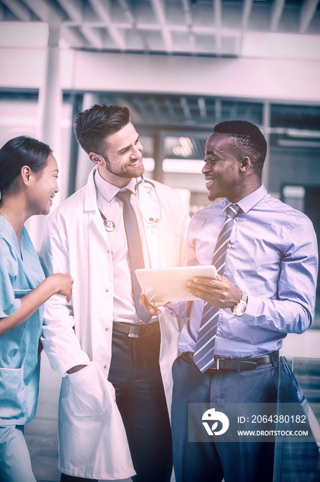 Nurse and doctor having discussion with businessman