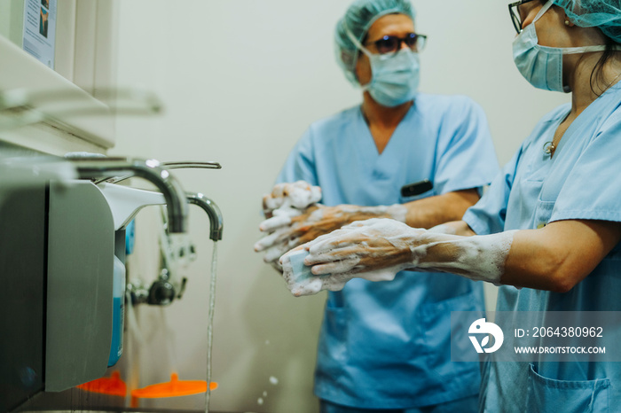 Unrecognizable doctor washing hands before operating