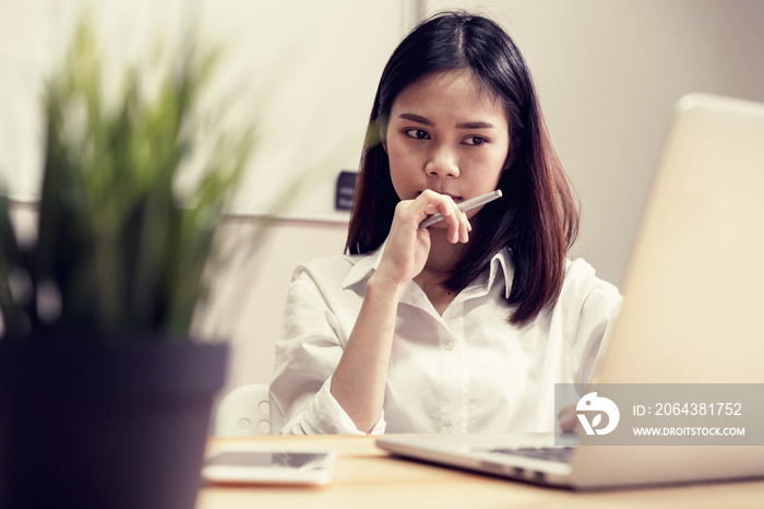 Businesswoman in office and use computer to perform financial accounting. To plan advance budget.