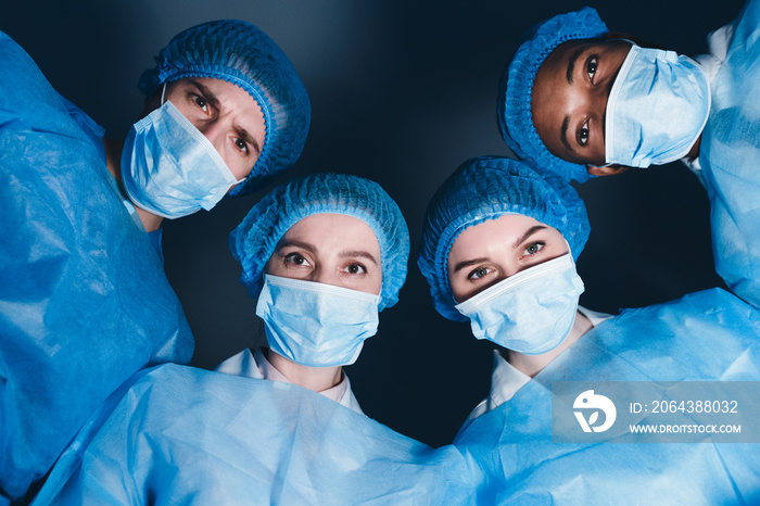 Doctors In Operation Theater Looking At Patient