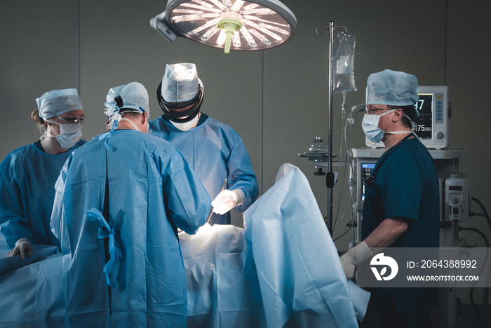 Group of surgeons using augmented reality holographic hololens glasses while operating in modern ope