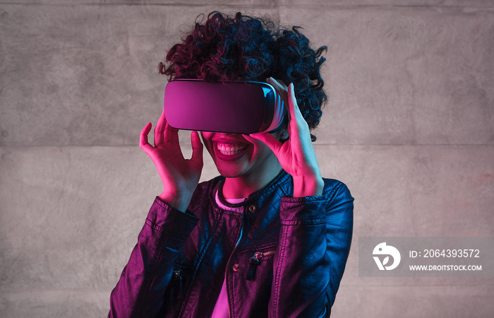 Cheerful black teenager wearing VR goggles