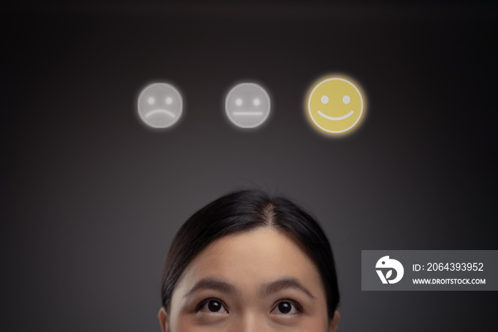 Feelings of Asian woman and emoticon hologram effect.