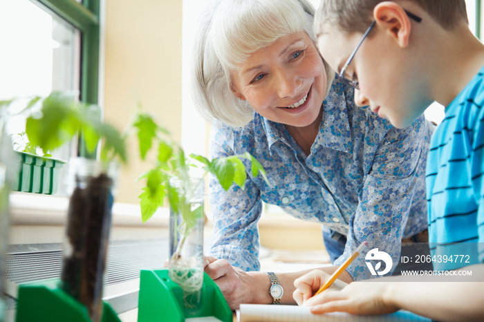 elementary student taking measurements of plant