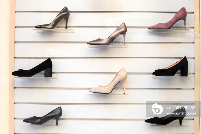 Womens shoes on shelves. Collection of shoe display in store window for sale