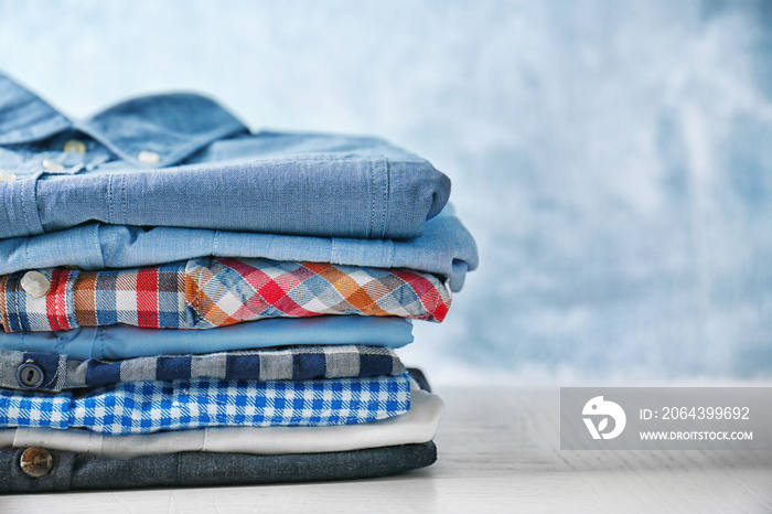 Stack of colorful clothes on blue background