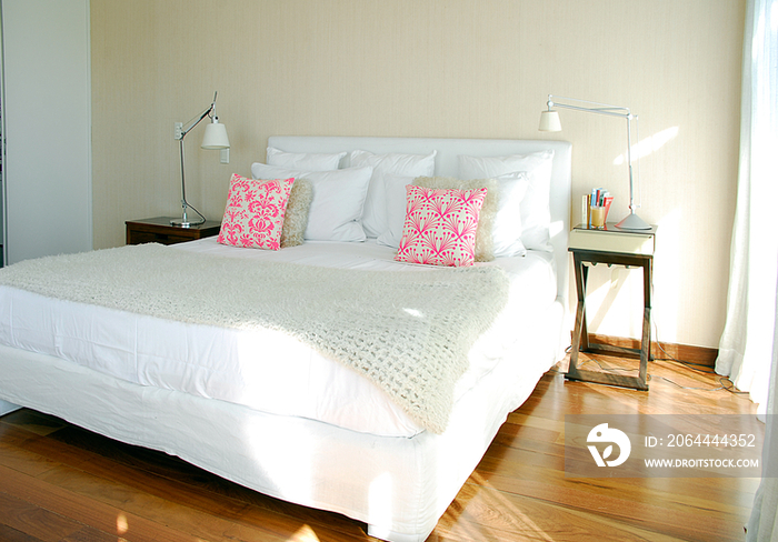 Bed and night table in bedroom; Argentina