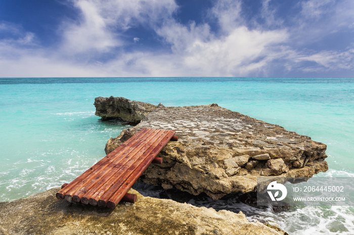 Wooden bridge across rocks on the coastline 