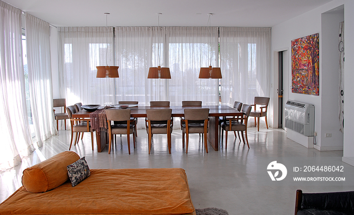 Dining table and pendant lights in house; Argentina