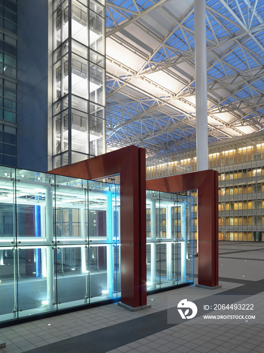 Red framed glass structure at courtyard in modern office building