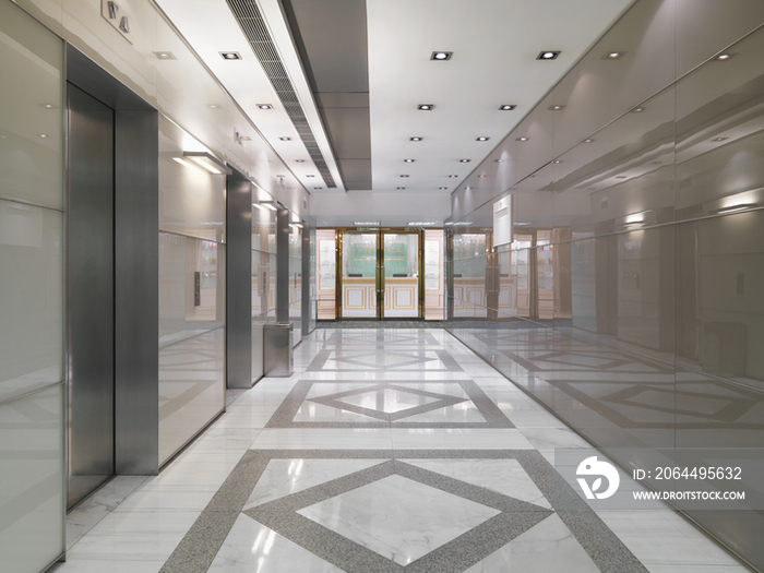 Elevators by corridor in spacious modern office