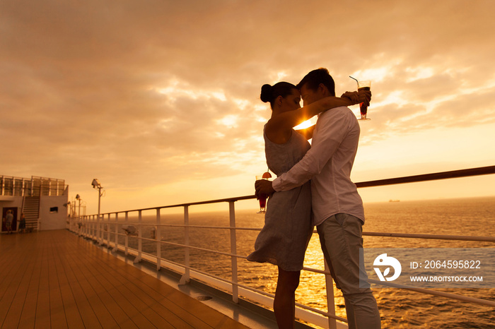 couple hugging with eyes closed at sunset on cruise