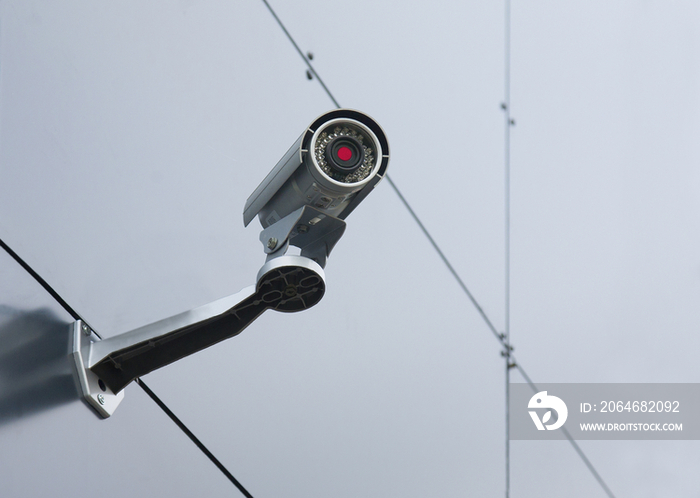 A security camera mounted on the wall of a building