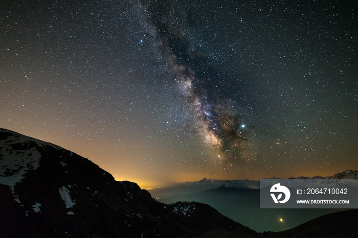 Milky way galaxy stars over the Alps, Mars and Jupiter planet, snowcapped mountain range, astro nigh