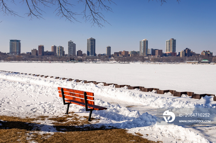 A bench along the shore of the Milwaukee, Wisconsin Harbor waits for springtime visitors 