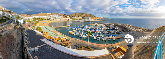 Panoramic aerial view of sea port and small bay of Puerto Rico de Gran Canaria holiday resort. Gran 