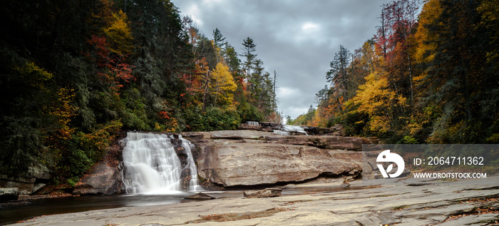 Triple Falls waterfall in fall color forest in the Appalachian mountains of North Carolina