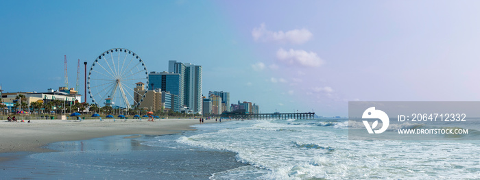 Panoramic view of Myrtle Beach, South Carolina with beach, hotels, ferris wheel, and boardwalk.