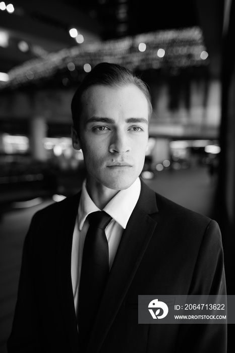 Young handsome businessman exploring the city streets at night