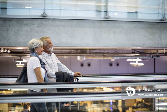 Senior couple traveling airport scene