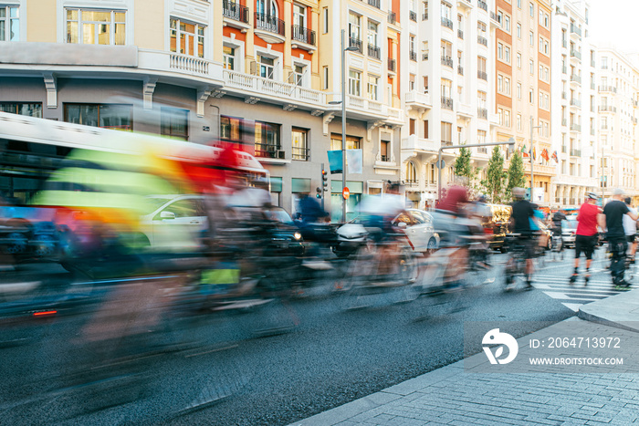 blurred group of cyclist riding on Madrid City Center