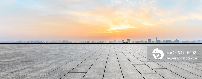 Panoramic city skyline and buildings with empty square floor at sunrise