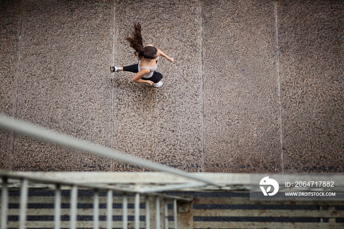 Overhead view of woman jogging on city street