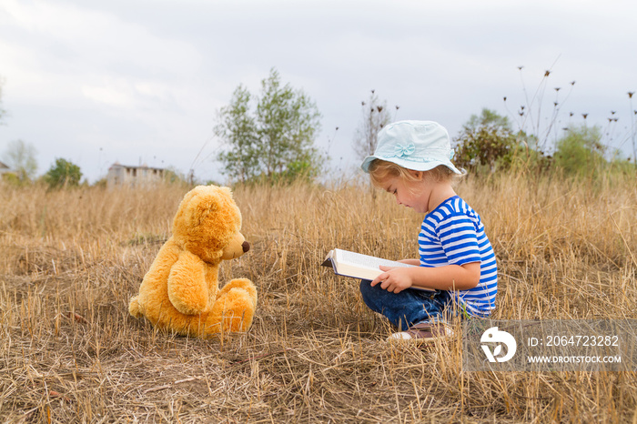 Cute girl reading book Teddy bear