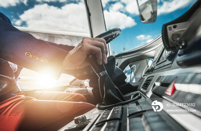 Bus Driver Behind Wheel Changing Gears.