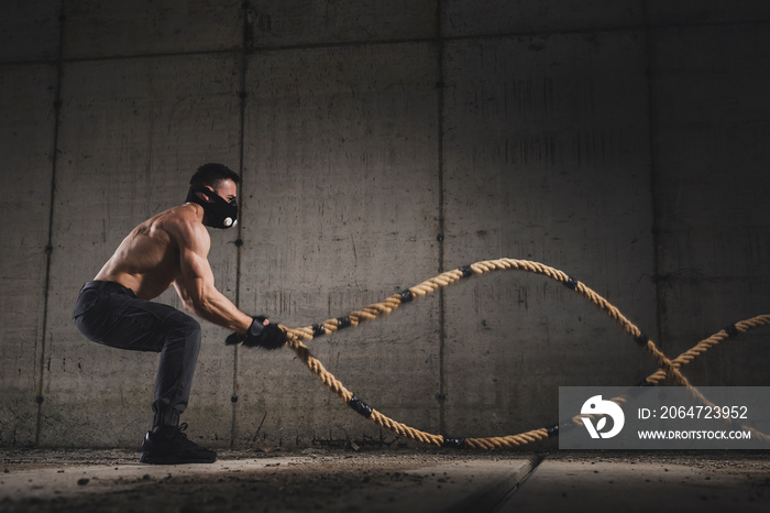 Athlete doing a battle ropes training