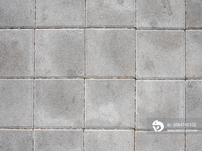 Paving stone background on city street. Mosaic modern pavement background texture close up.