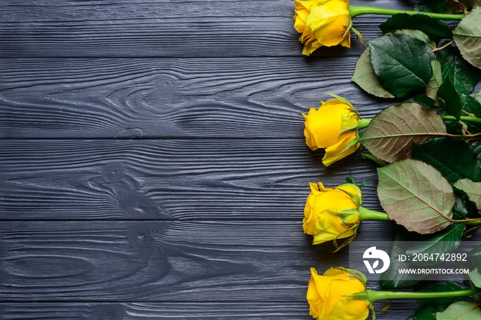 Beautiful yellow roses on wooden background