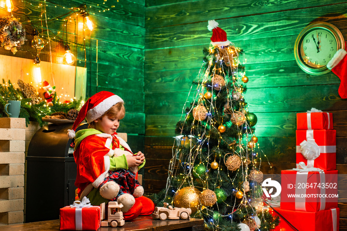 Family day christmas. Gifts and surprises. Cute little child boy play near christmas tree. Merry chr