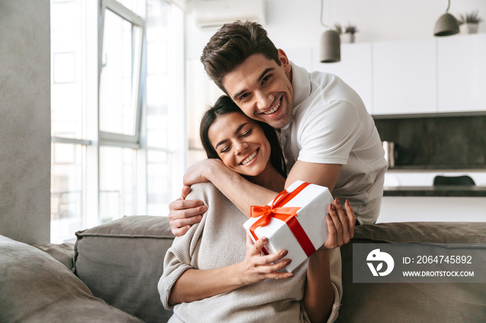 Happy lovely young couple celebrating together