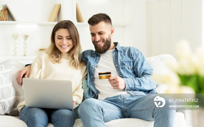 E-shopping. Happy Couple Using Credit Card, Surfing Internet