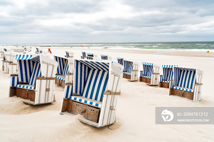 Beach - chairs on the island Sylt. Germany.  Summer cloudy weather.