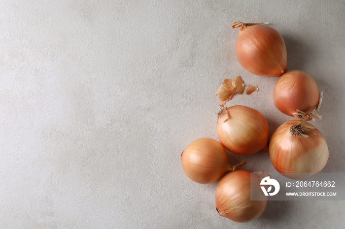 Fresh ripe onion on white textured background