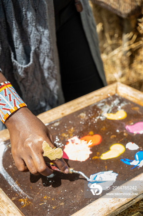 artist mixing paint on her palette