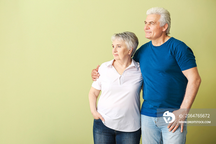 Portrait of senior couple on color background