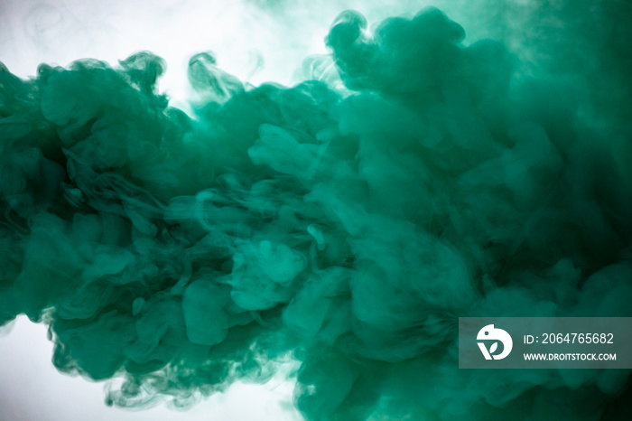 Green smoke bomb exploding against white background