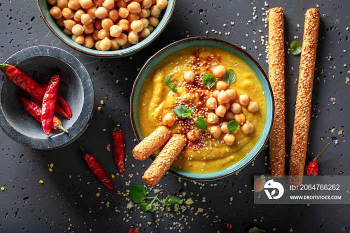 Vegan chickpea soup with sesame seeds and hot chilli pepper.